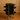 Black rolling cart with multiple compartments on a wooden floor.