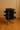 Black rolling cart with multiple compartments on a wooden floor.