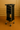 Black rolling cart with multiple shelves against a beige wall.